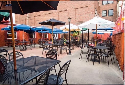 Colorful outdoor patio seating at Botanas Restaurant